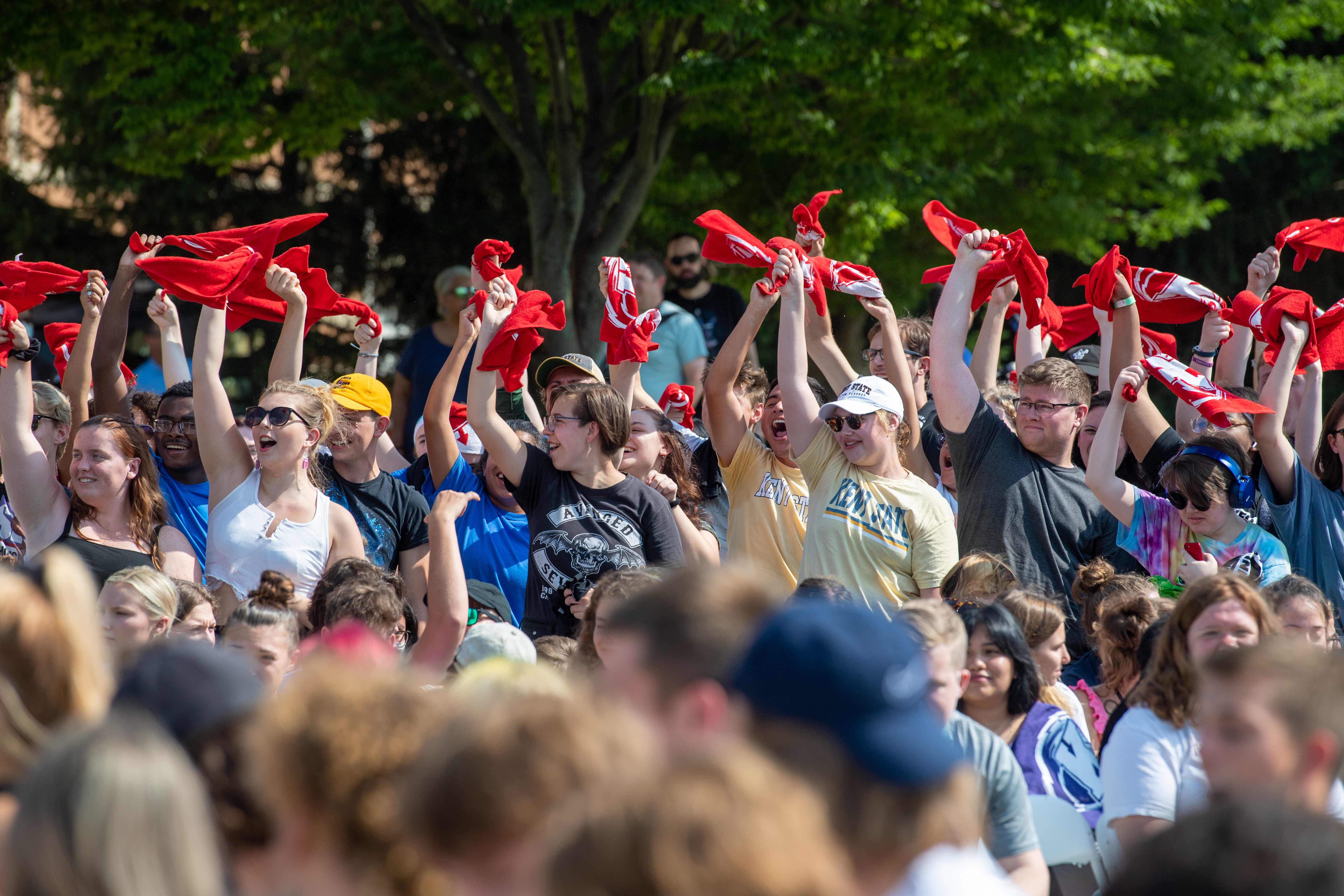 Students waving shirts at Convocation