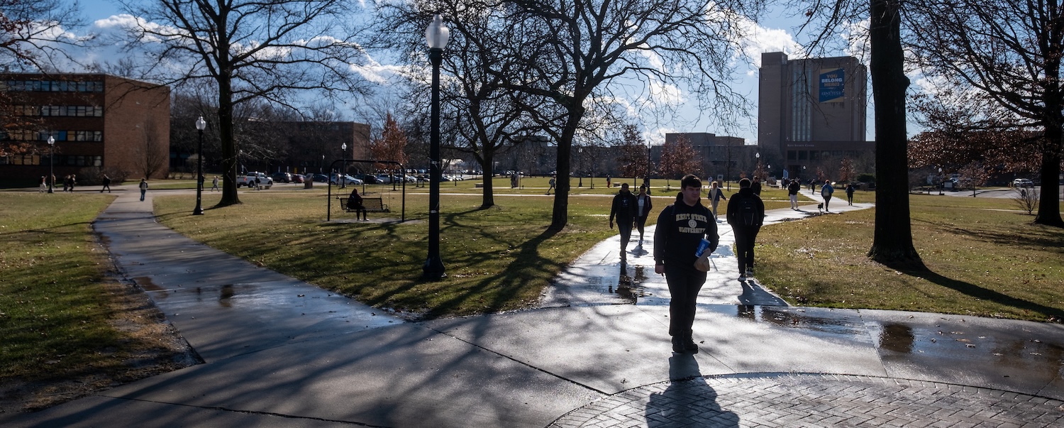 Students walk campus in January with long shadows