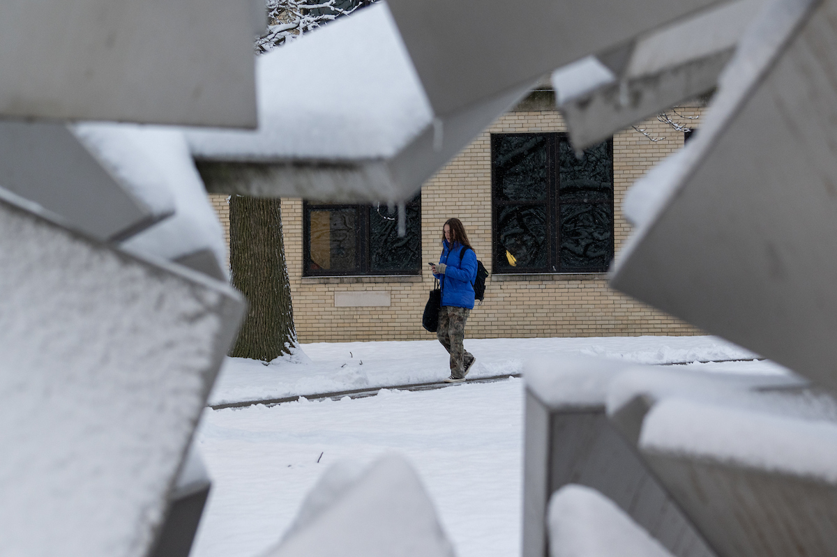 A snowy scene, framed by the "Star Sphere 2010" sculpture, near Front Campus.