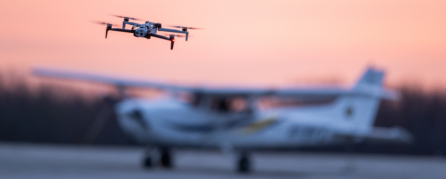 drone with airplane parked in background