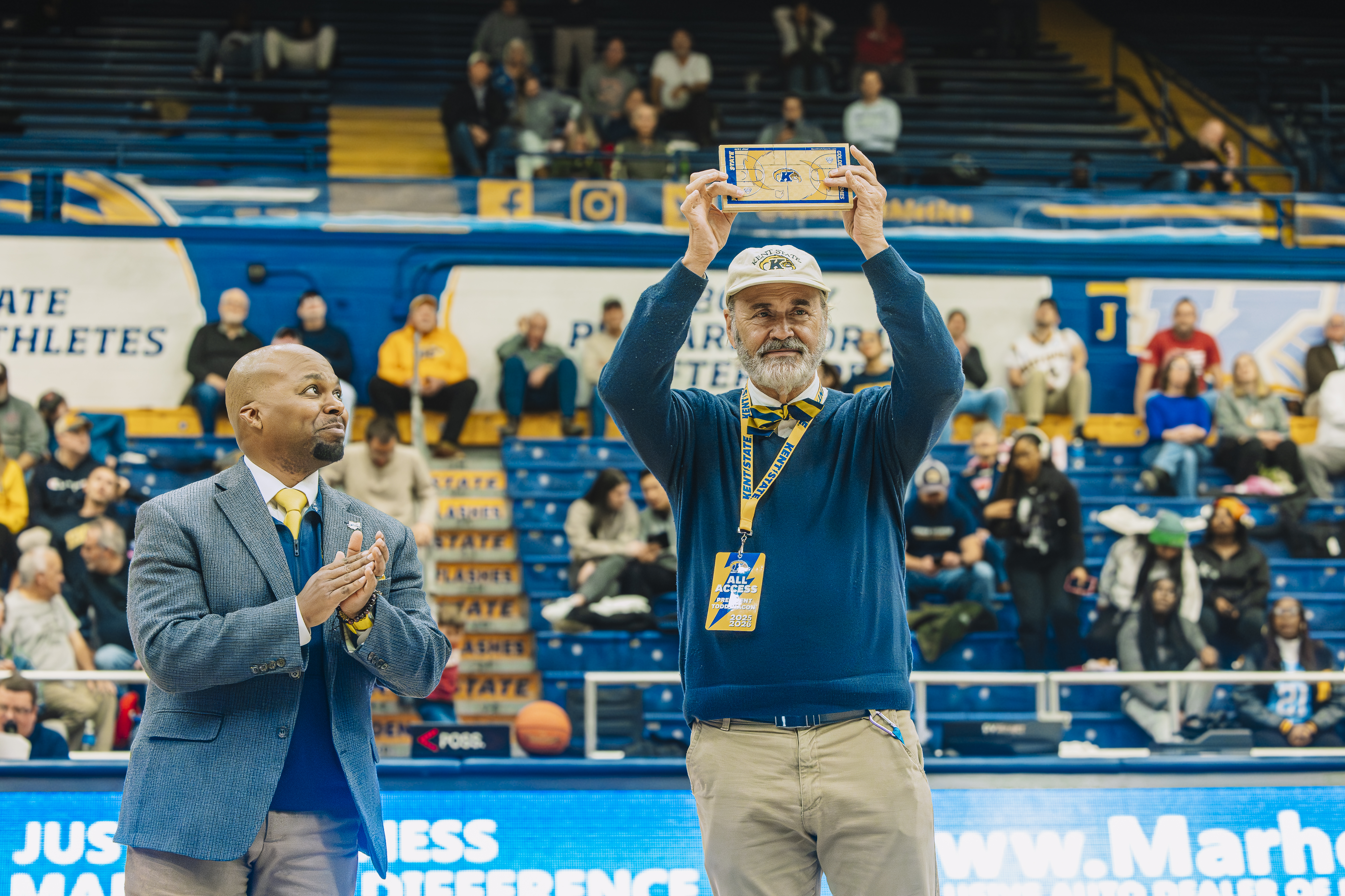 President Diacon accepts a piece of the MAC Center hardwood
