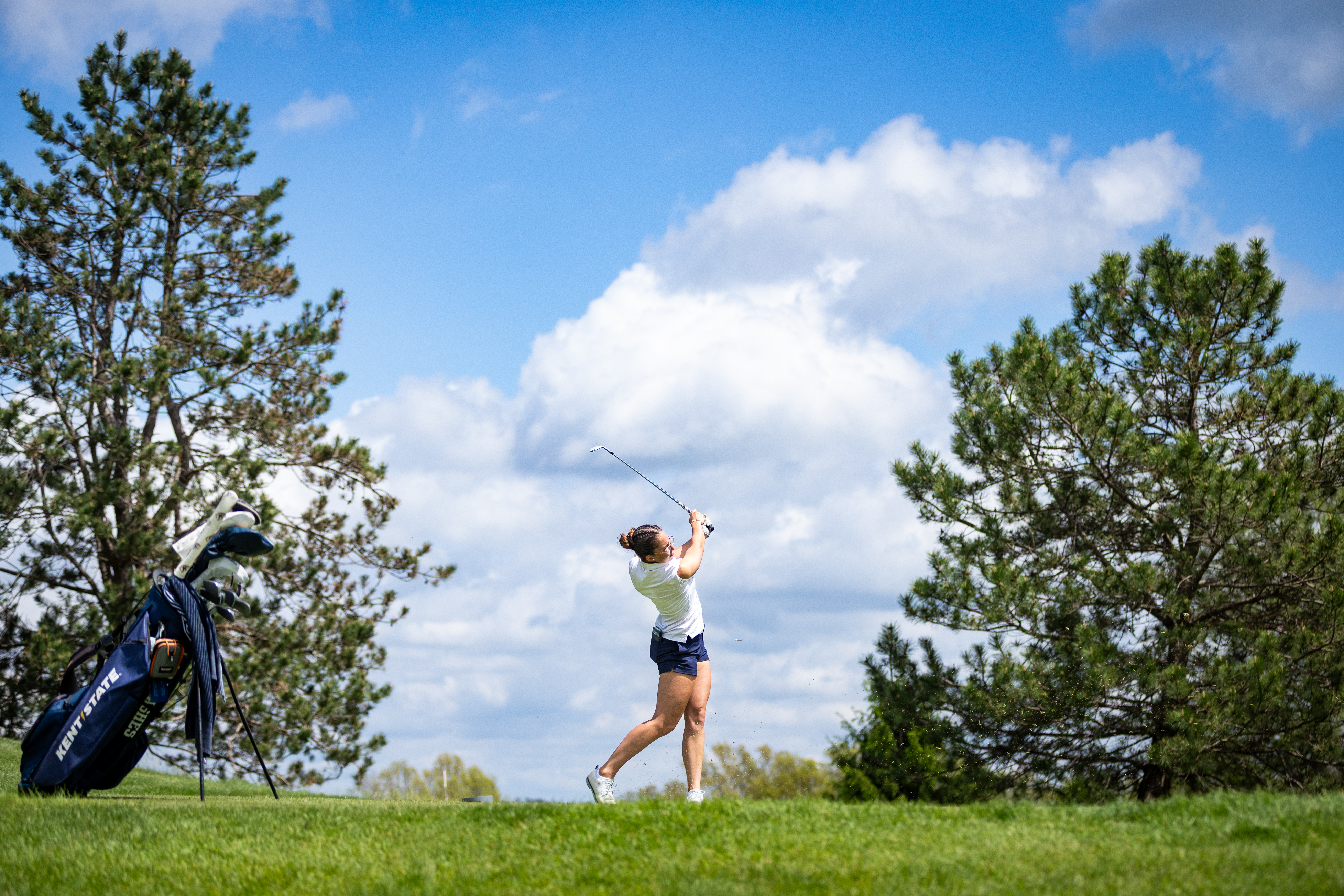 Woman's golf player swinging her club