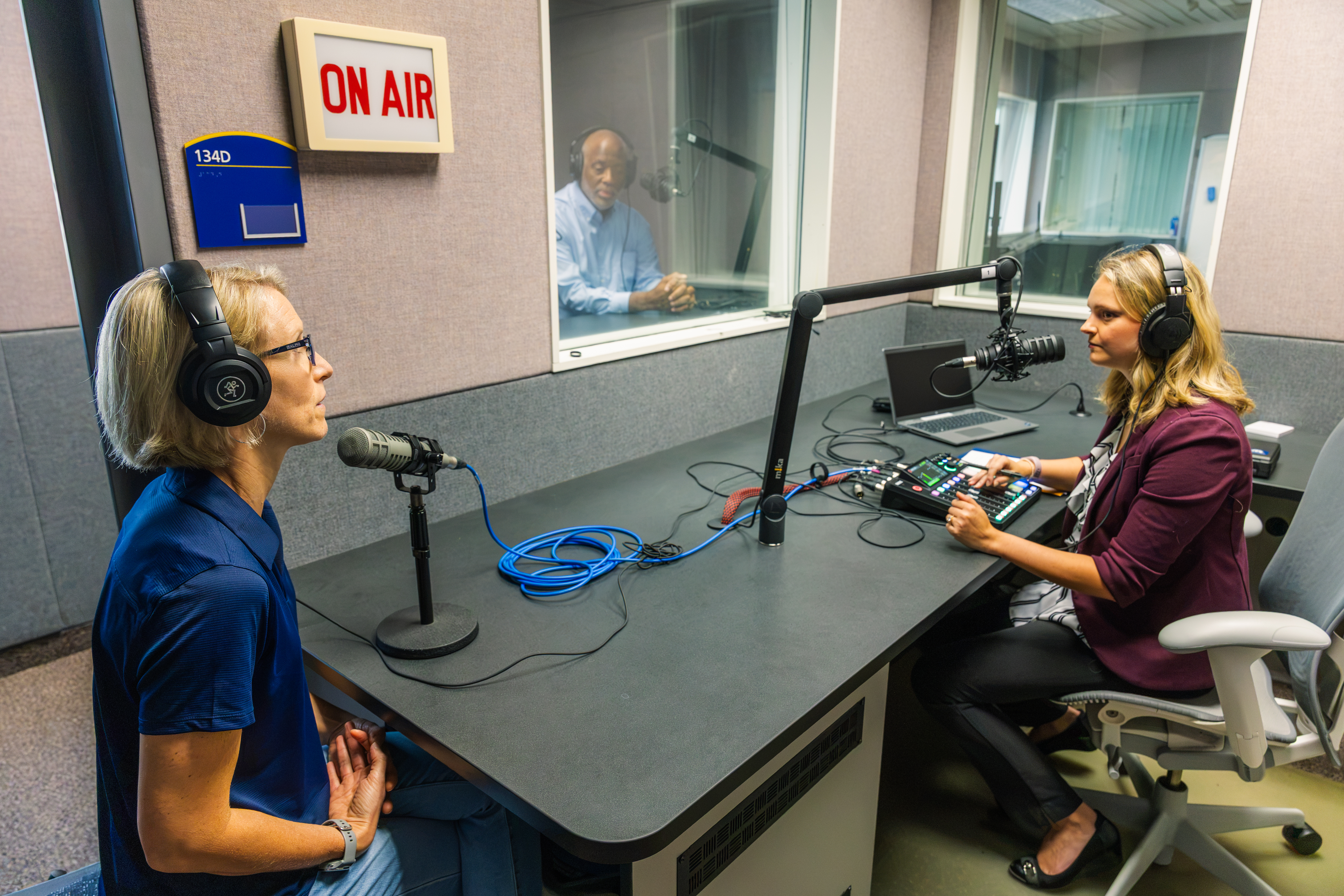 Anna Huntsman interviews several professors, including Dr. Gretchen Hoak (left) and Mizell Stewart III.