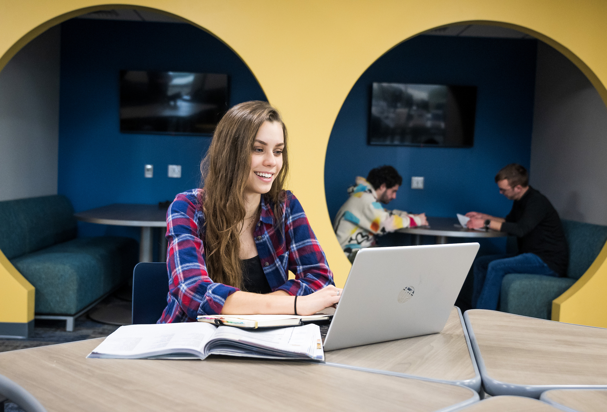 Student smiles at computer