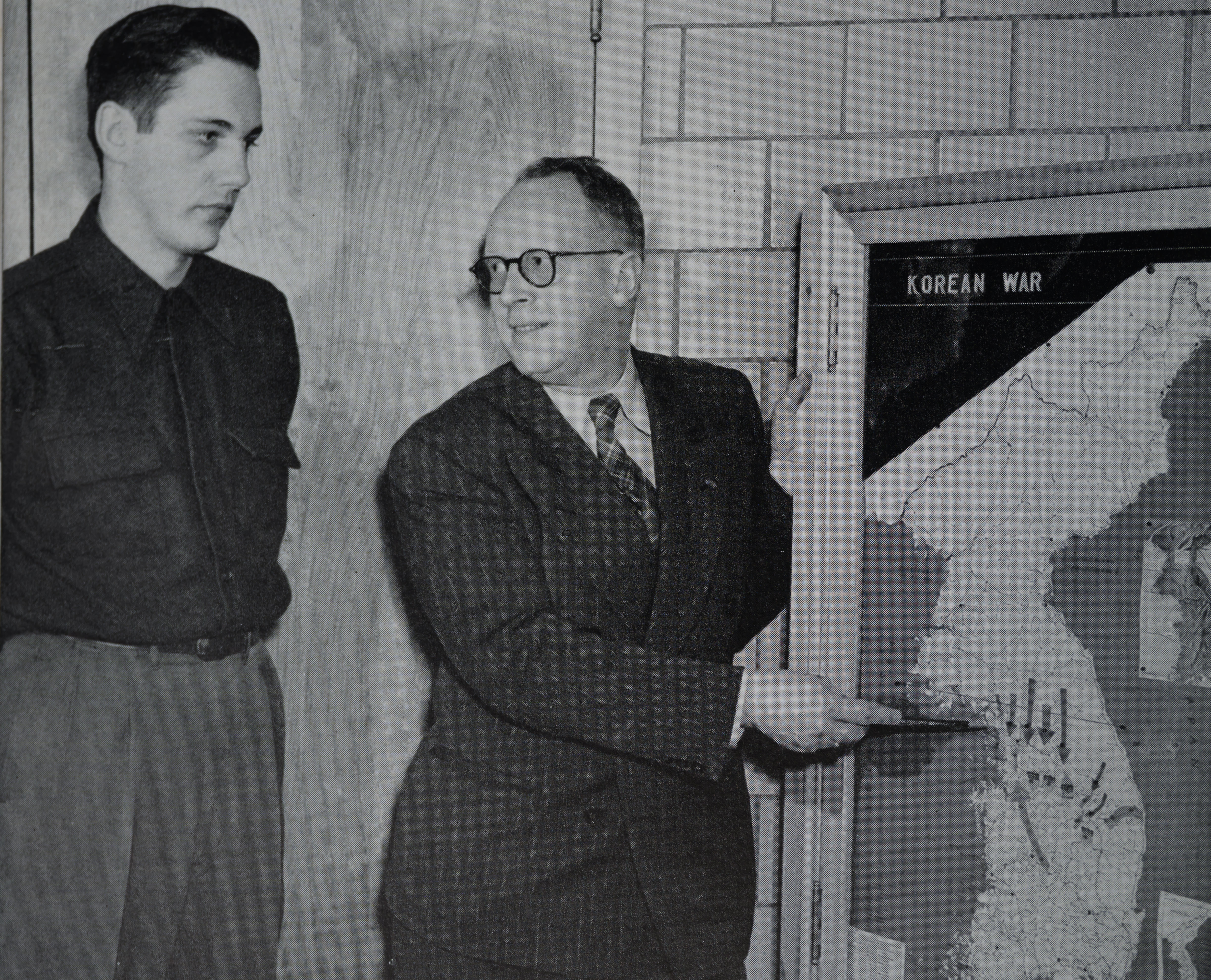 Teaching showing a map of Korea during Korean War conflict in 1951