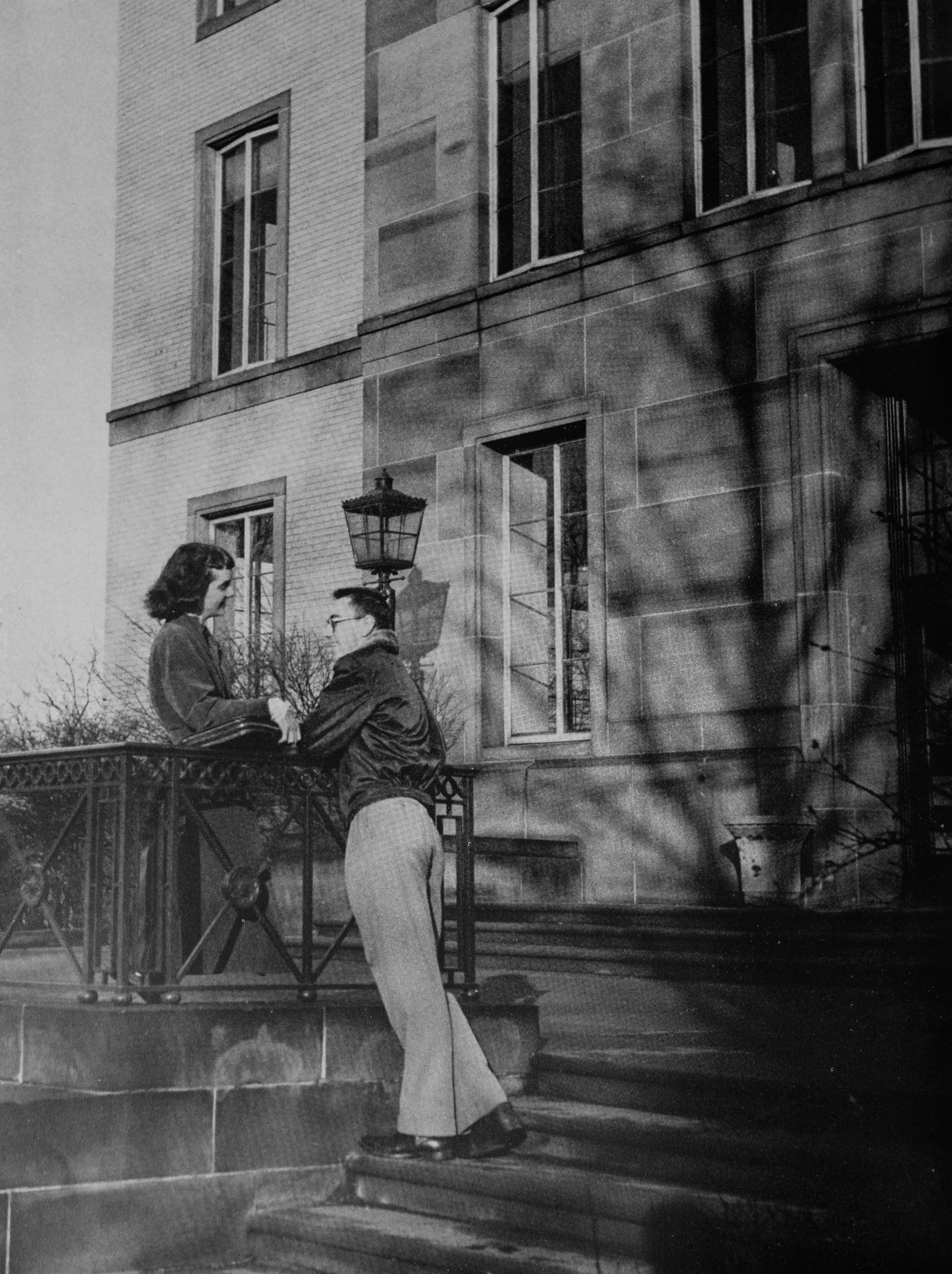 Two students hanging out on campus in 1951