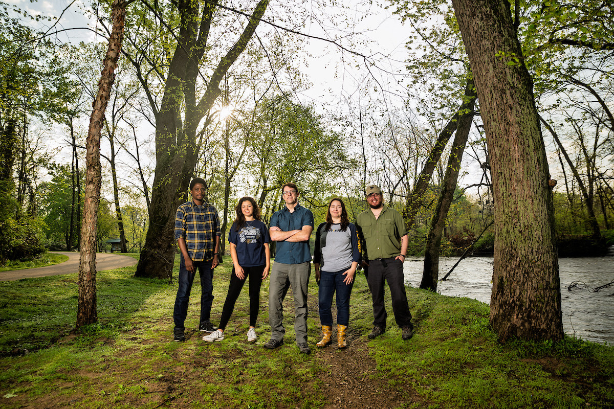 David Costello and a team of researchers standing by the stream