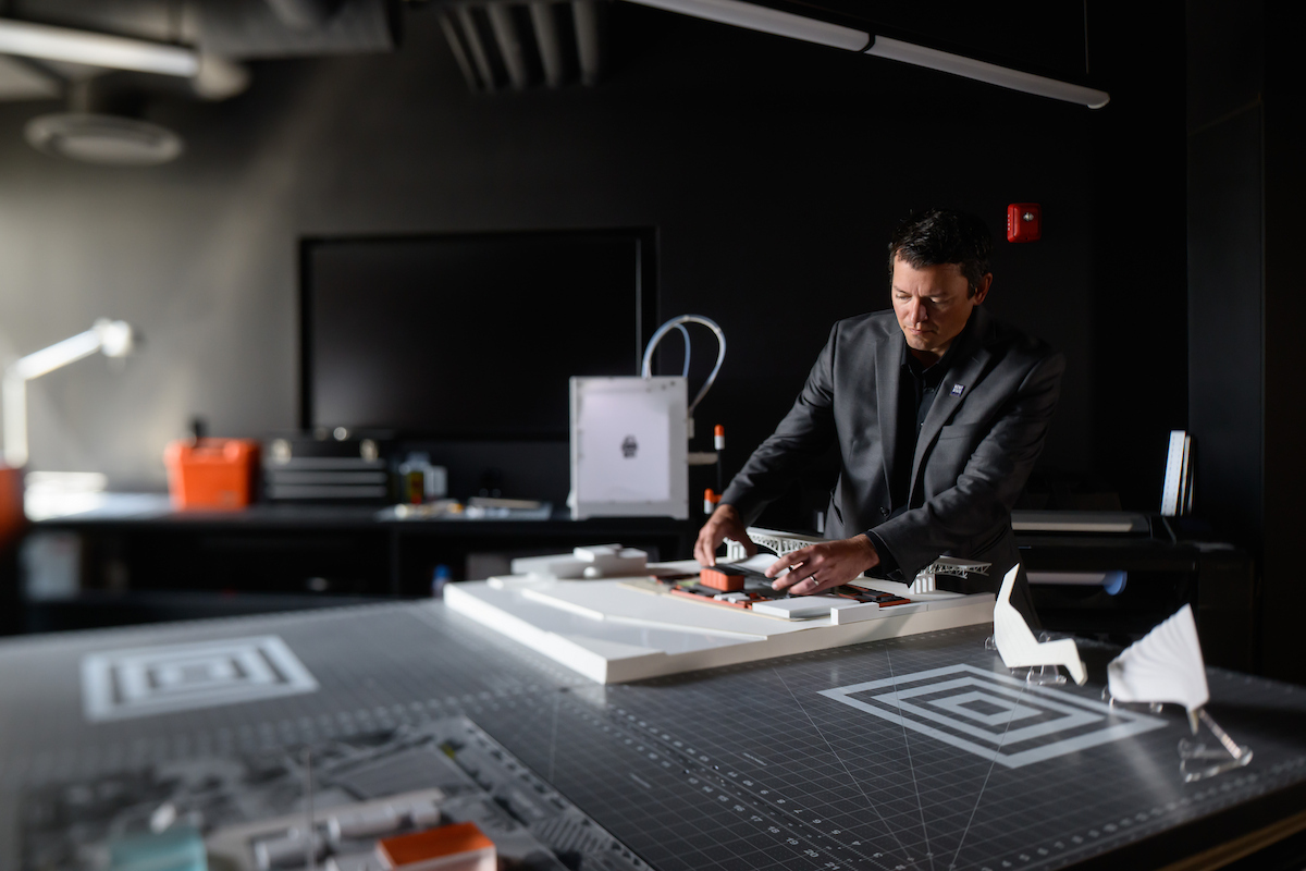 Mark Morris looking at models in the Cleveland office of the DLR Group