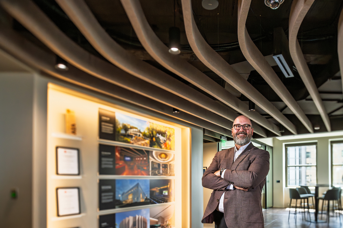 Josh Haney standing in the Cleveland office of the DLR Group