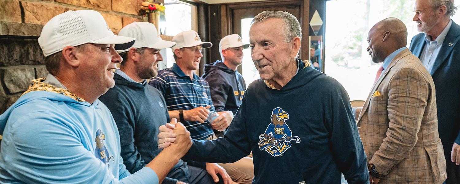 Coach Herb Page greets alumni of Kent State's golf program