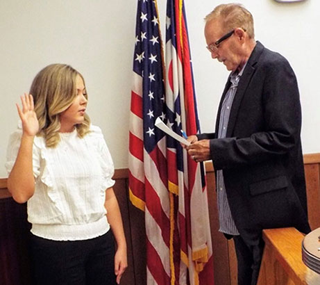 Maia Amato takes her seat at the Wellsville Village Council table. Maia Amato takes her seat at the Wellsville Village Council table.
