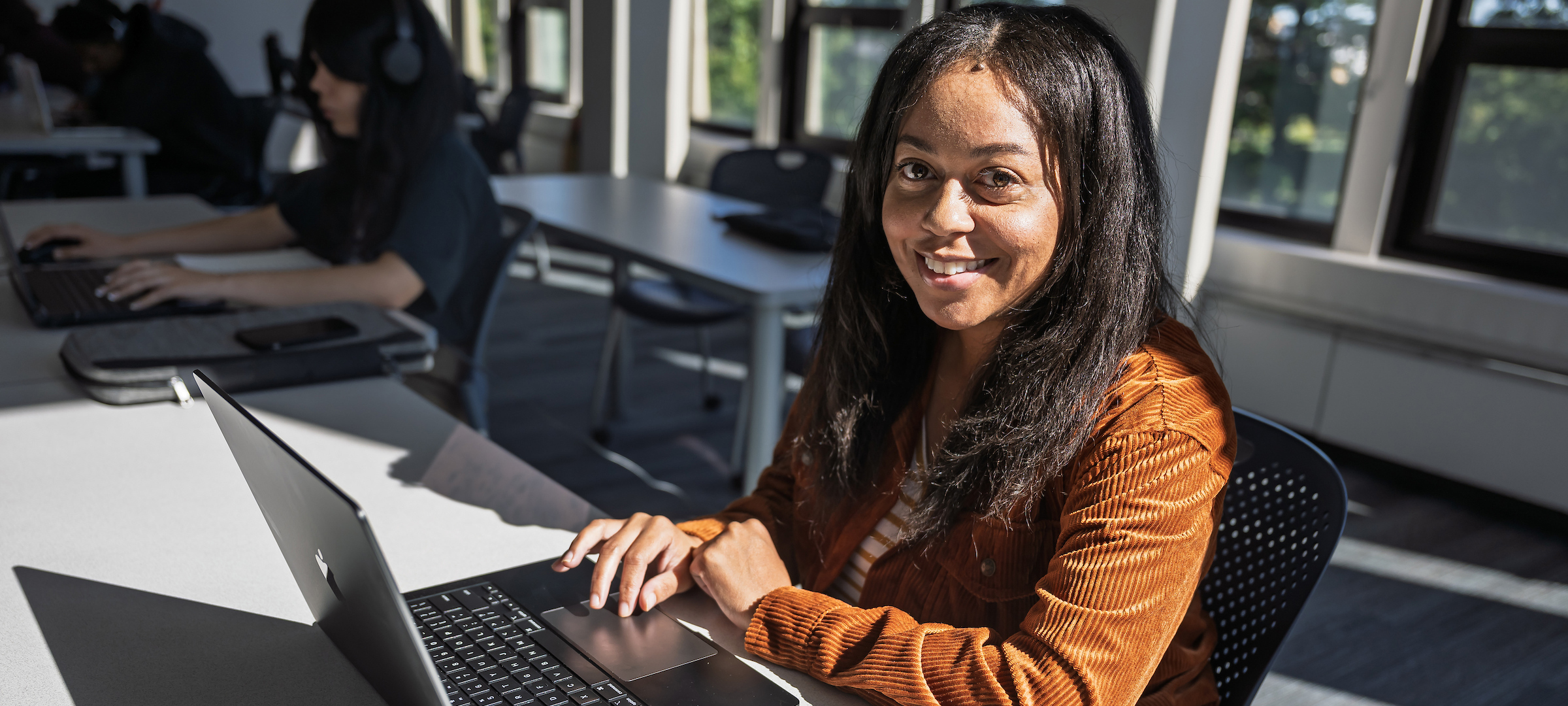 A student with her laptop in class