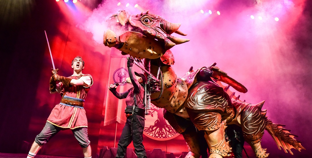 Dragons and Mythical Beast scene with actors and large dragon puppet