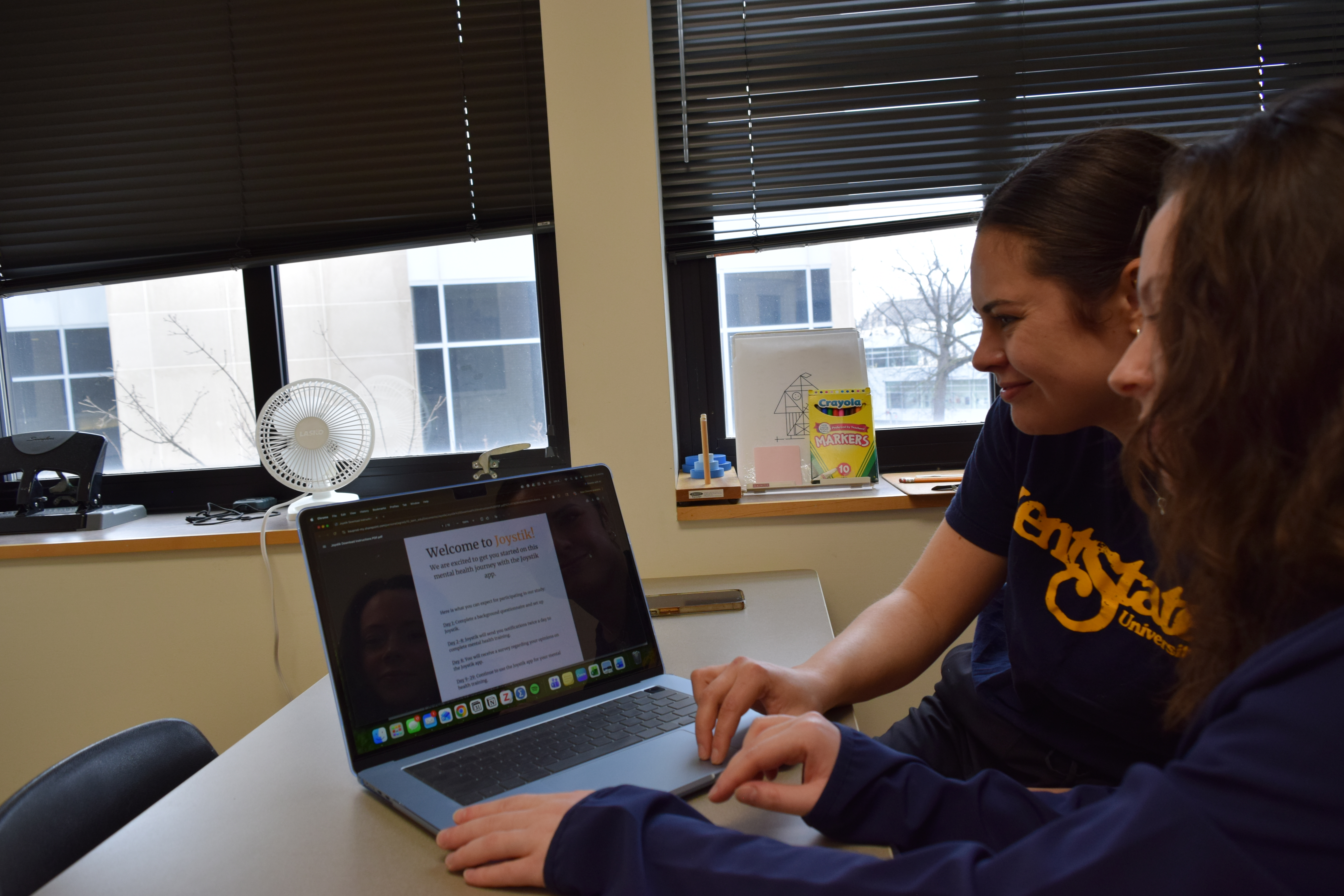 Alli Grady and Eleanor Siegle discuss the Joystik Life app while working in the SHIPP Lab in Kent Hall on the Kent Campus