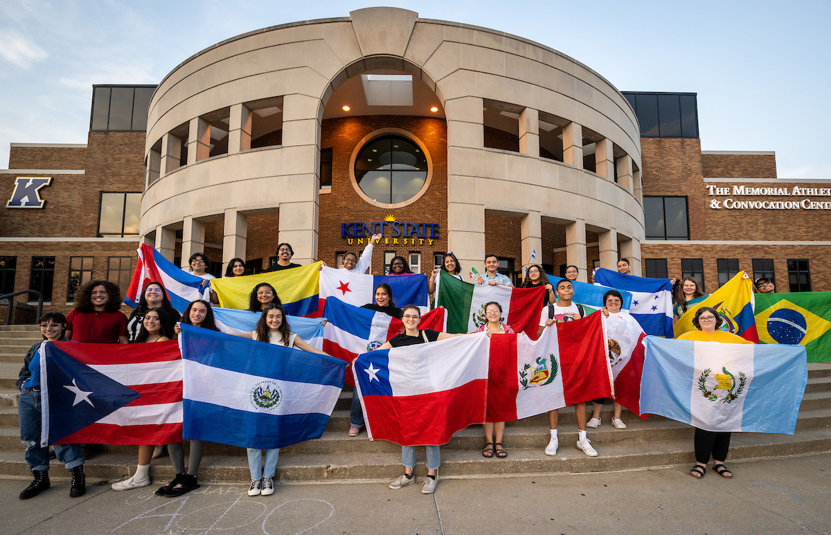 Students holding flags of Latin American countries. 