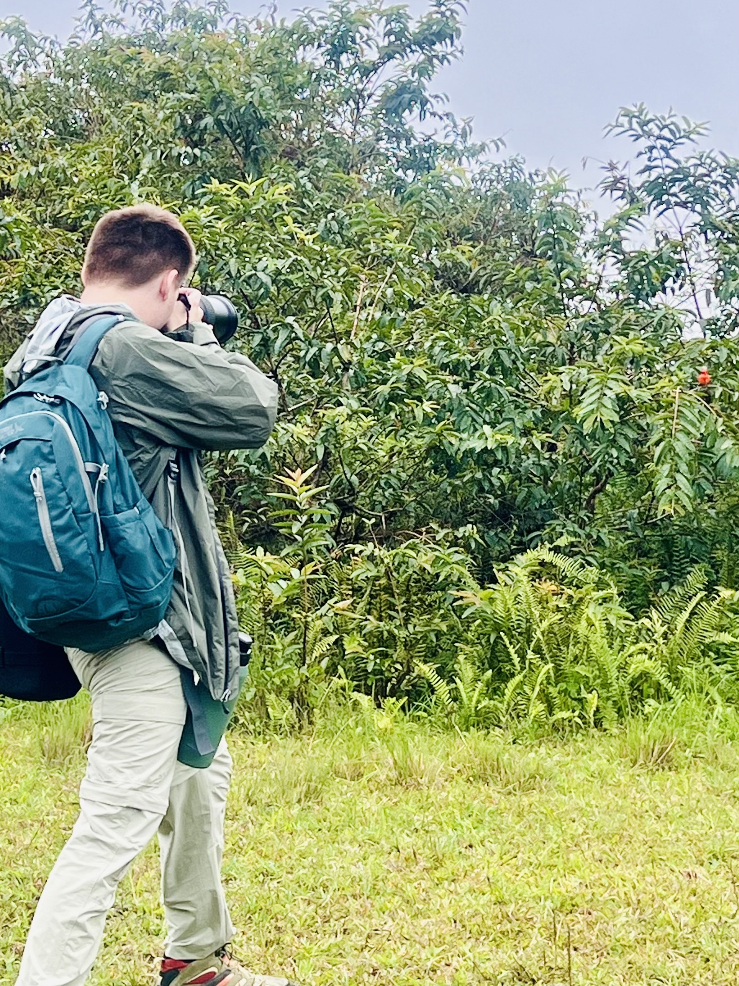 Dalton photographing a bird in the Galapagos