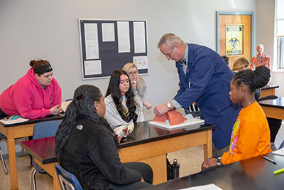 Dr. Dankovich interacting with students in his lab. Dr. Dankovich interacting with students in his lab.