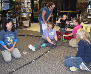 Faculty and students from the early childhood education program helped youngsters build roller coasters Faculty and students from the early childhood education program helped youngsters build roller coasters