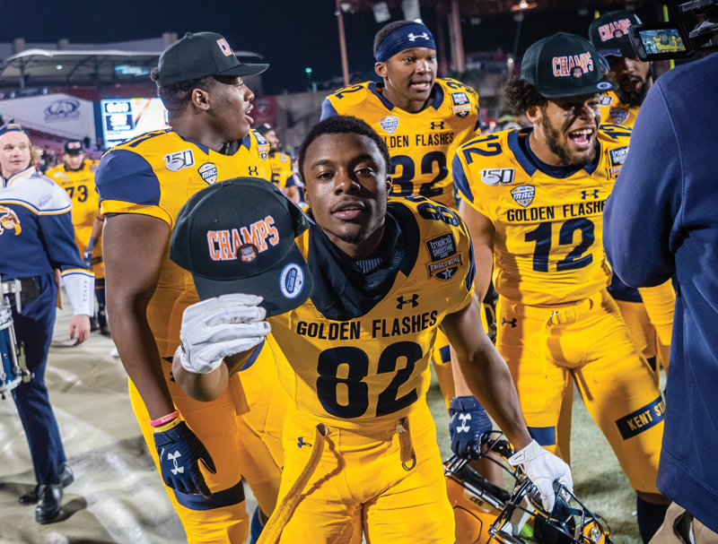 A ϲ football player with a champion hat after winning the Frisco bowl. 