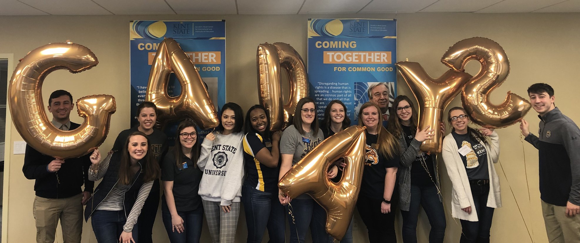 Master's students holding balloons that spell GA DAYS.