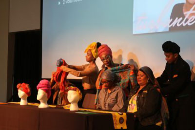 Photograph of on-stage head-wrapping demonstration