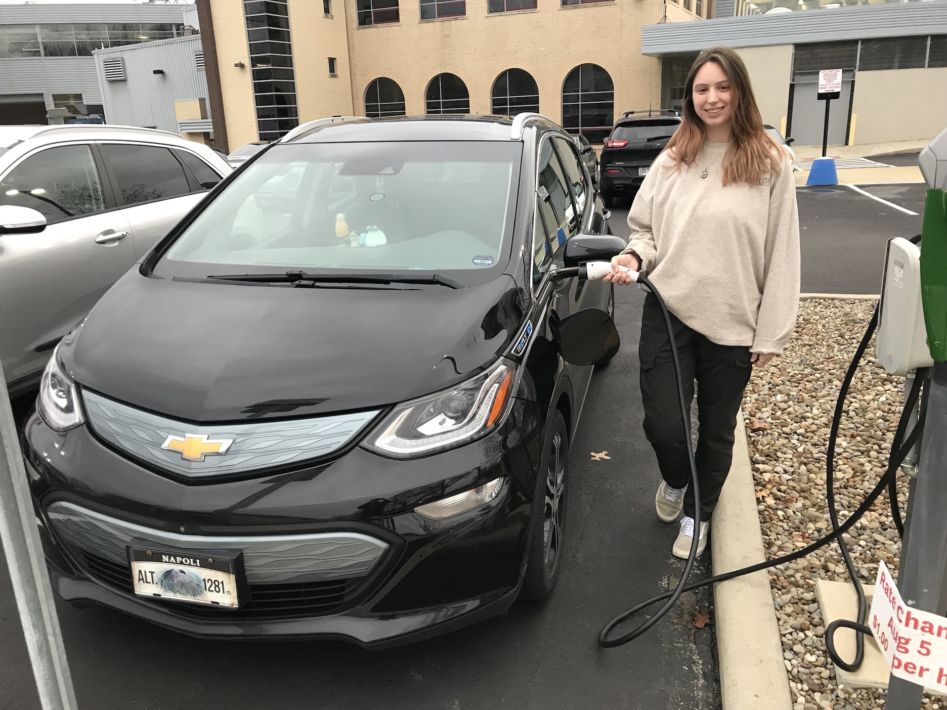 Senior geology student, Athena Vohs and her Chevrolet Bolt EV. A student using one of the on-campus EV charging stations.