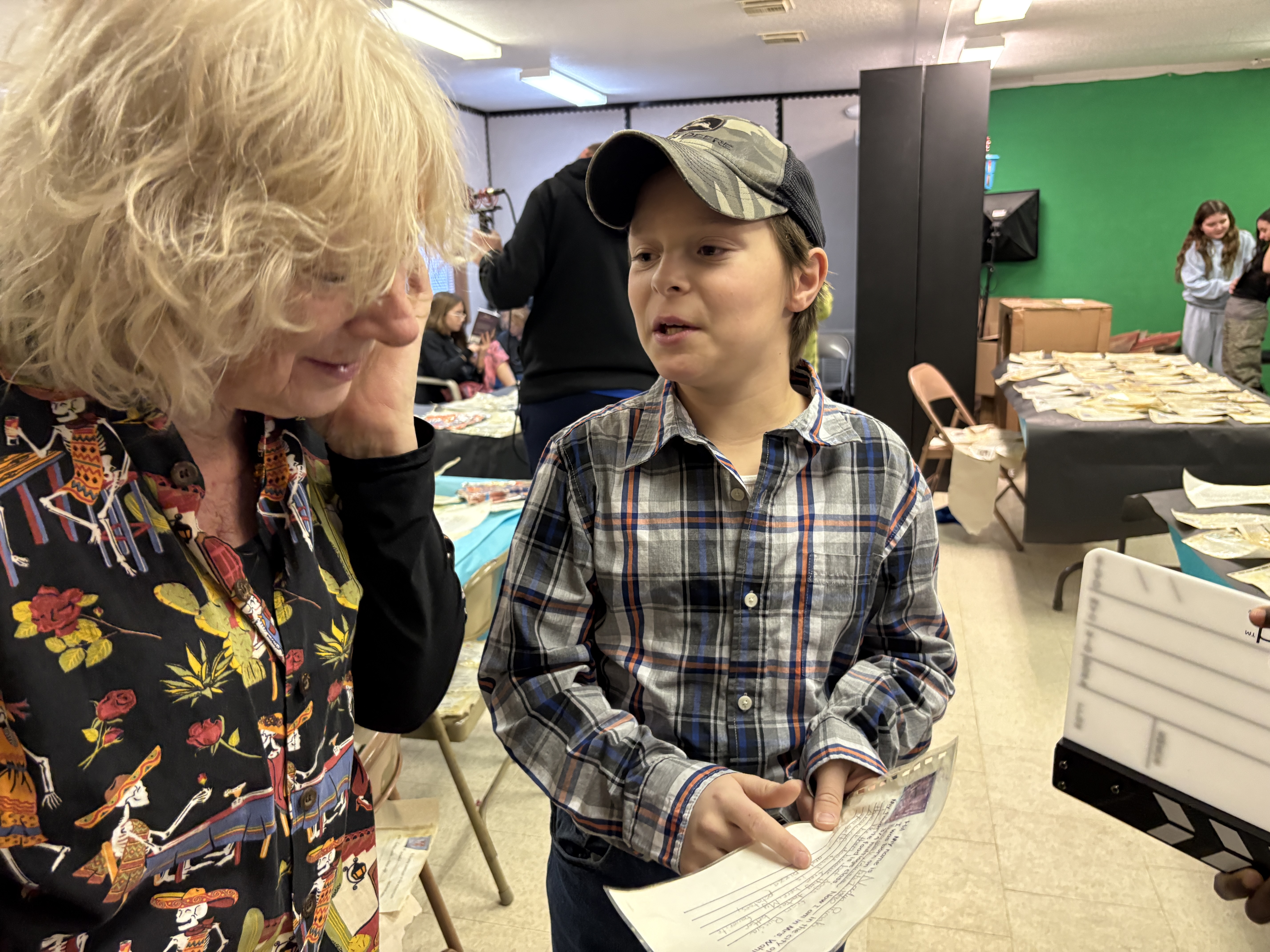 Linda Spurlock (left) discusses the artifacts with one of the Walls students