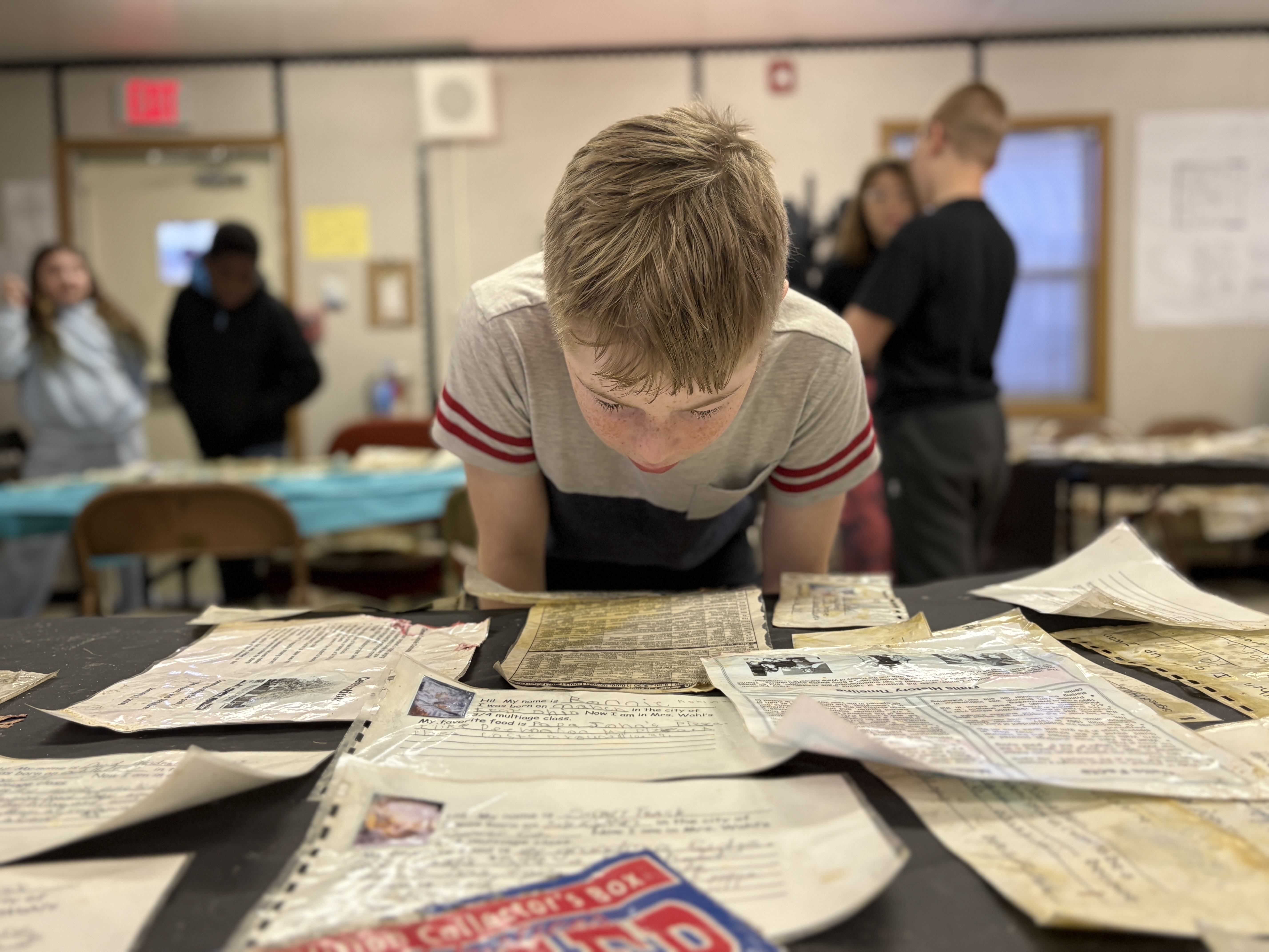 A Walls student takes a closer look at some of the artifacts that were dug up