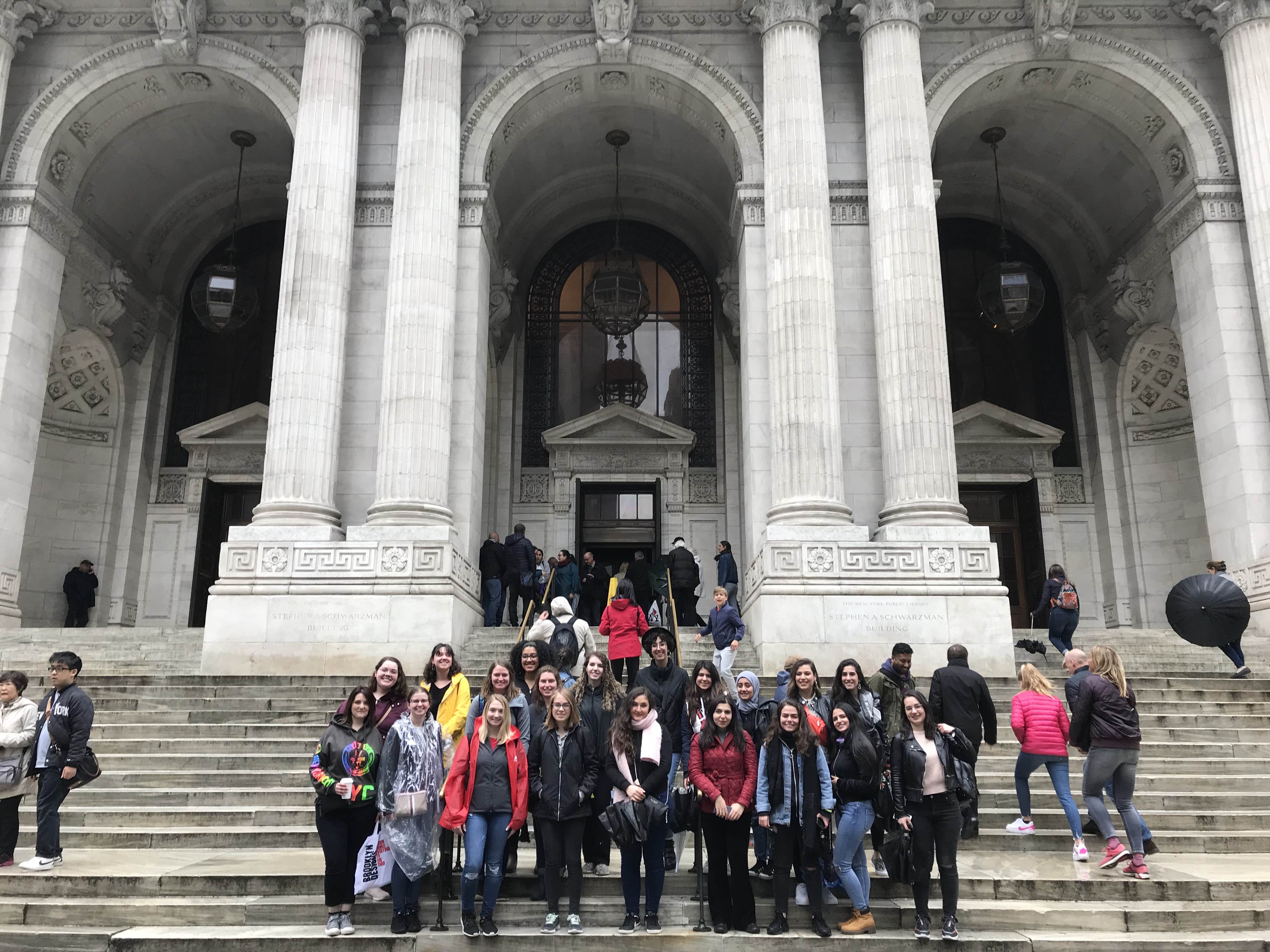 students posing outside of a building in nyc