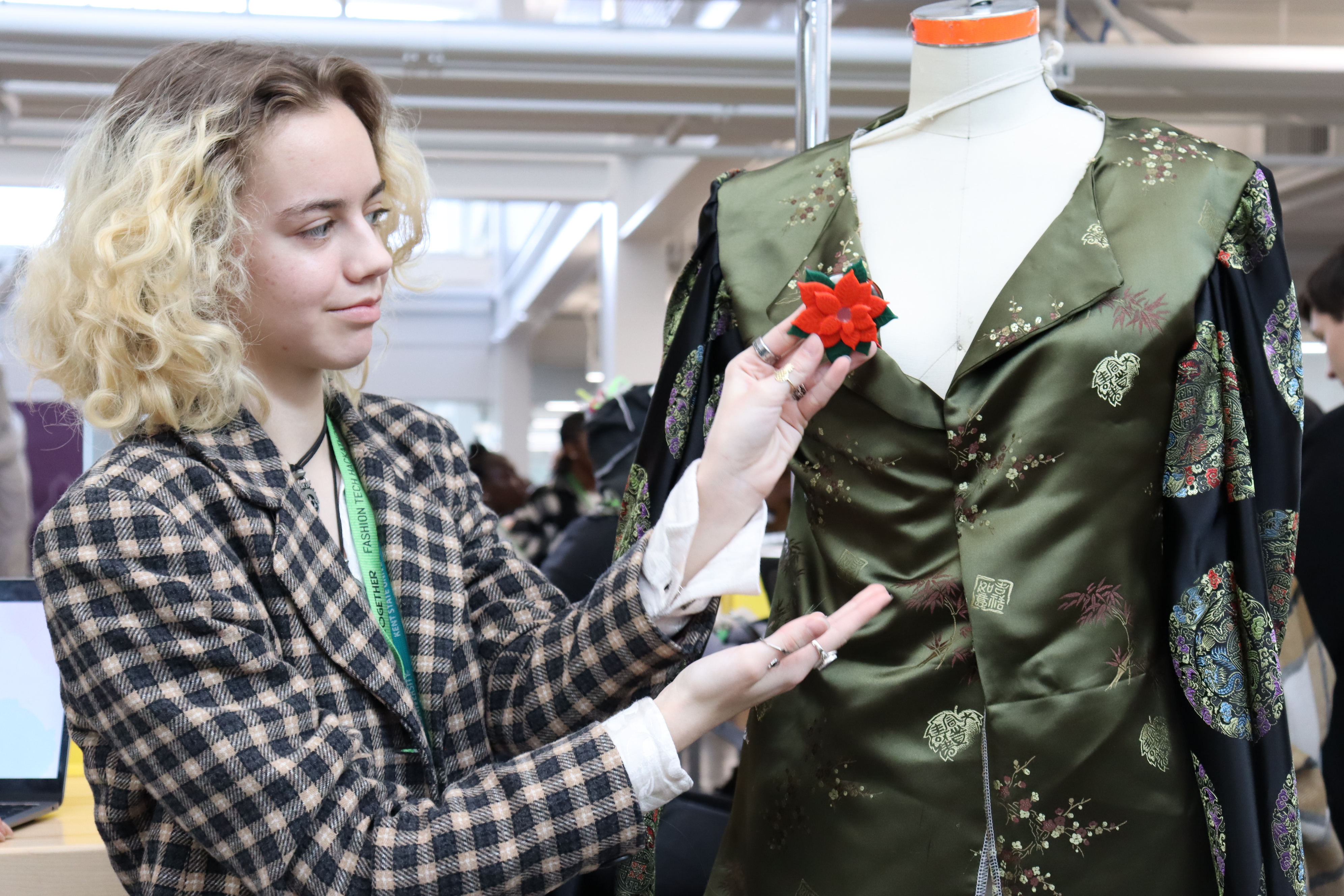 Student showcasing wearable technology on a mannequin