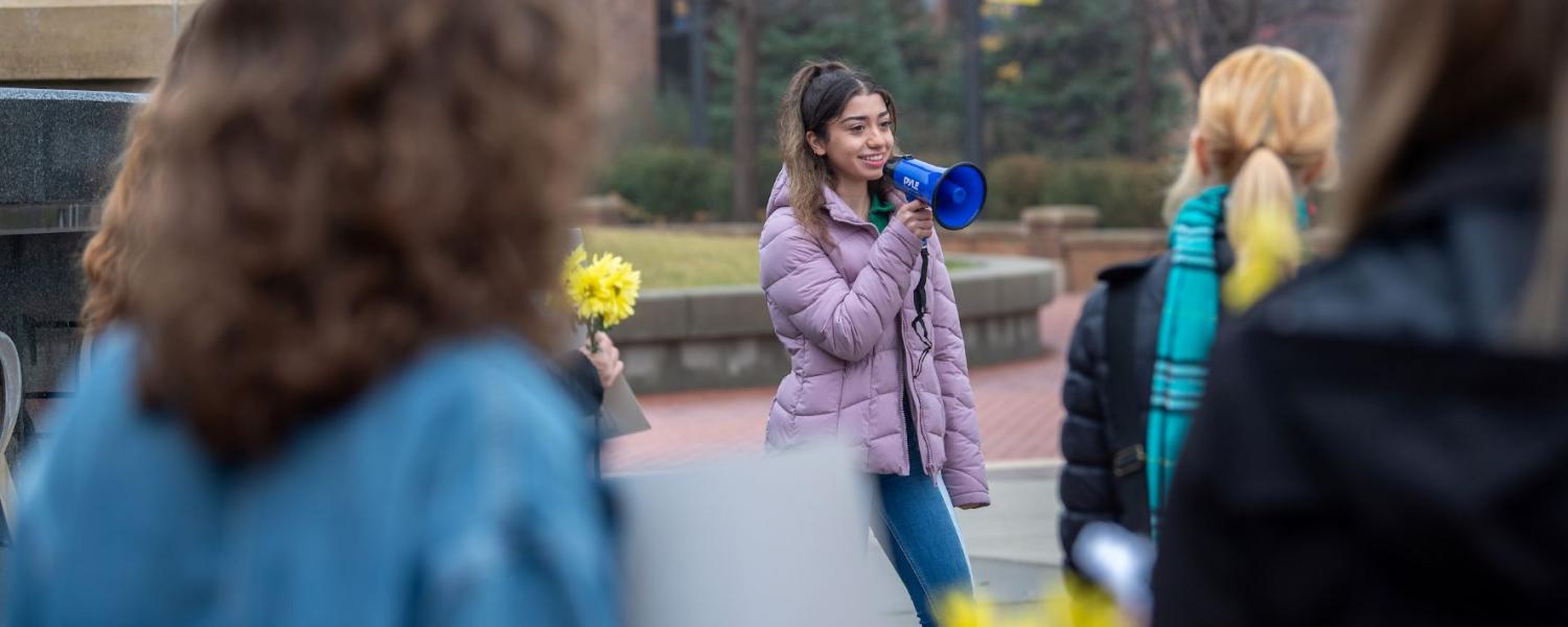 First-year student Ronica Marandi speaks to the crowd about how they can help Iranians.