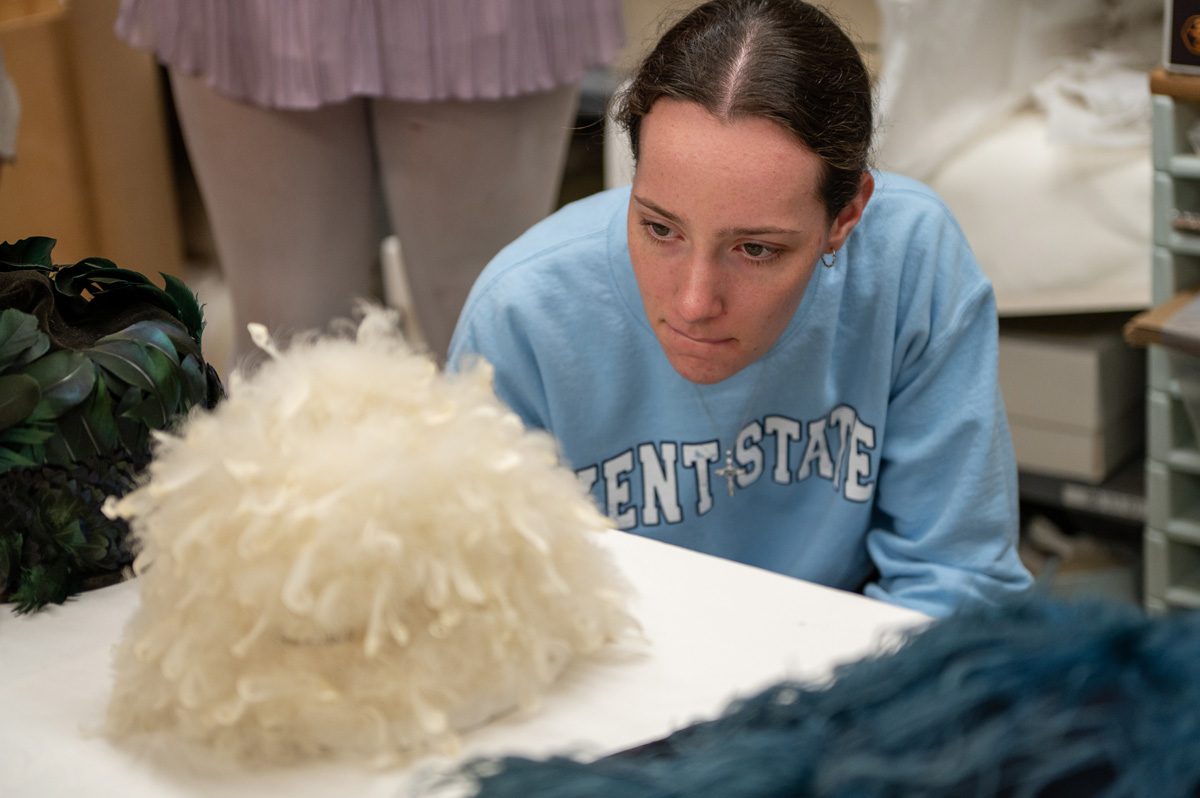 51�Թ��� fashion student looking at feathers at 51�Թ��� Fashion Museum