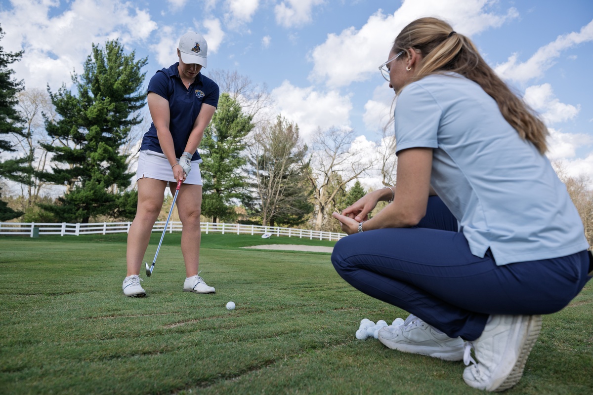 Manu coaching a player's swing