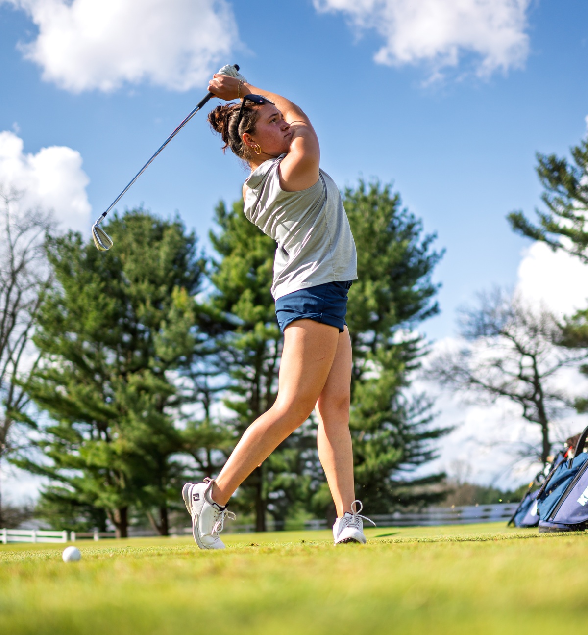 Women's golf player swinging her club