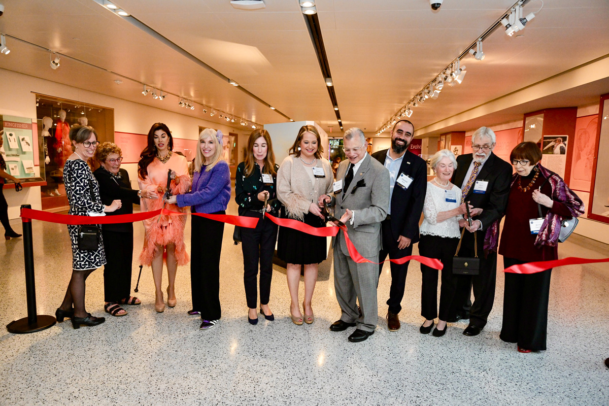 Cutting the ribbon of the Fashion and Feathers exhibit