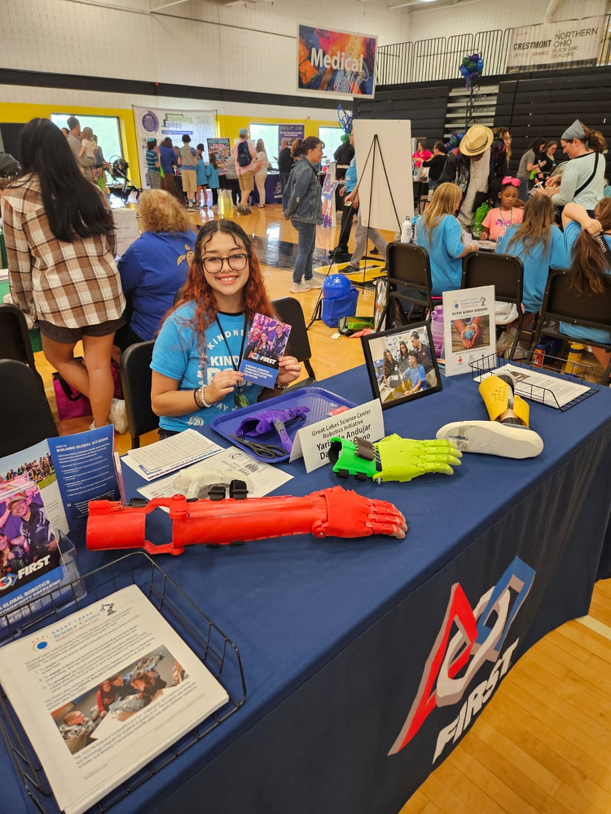 Yari at a table explaining her prosthetic hand project
