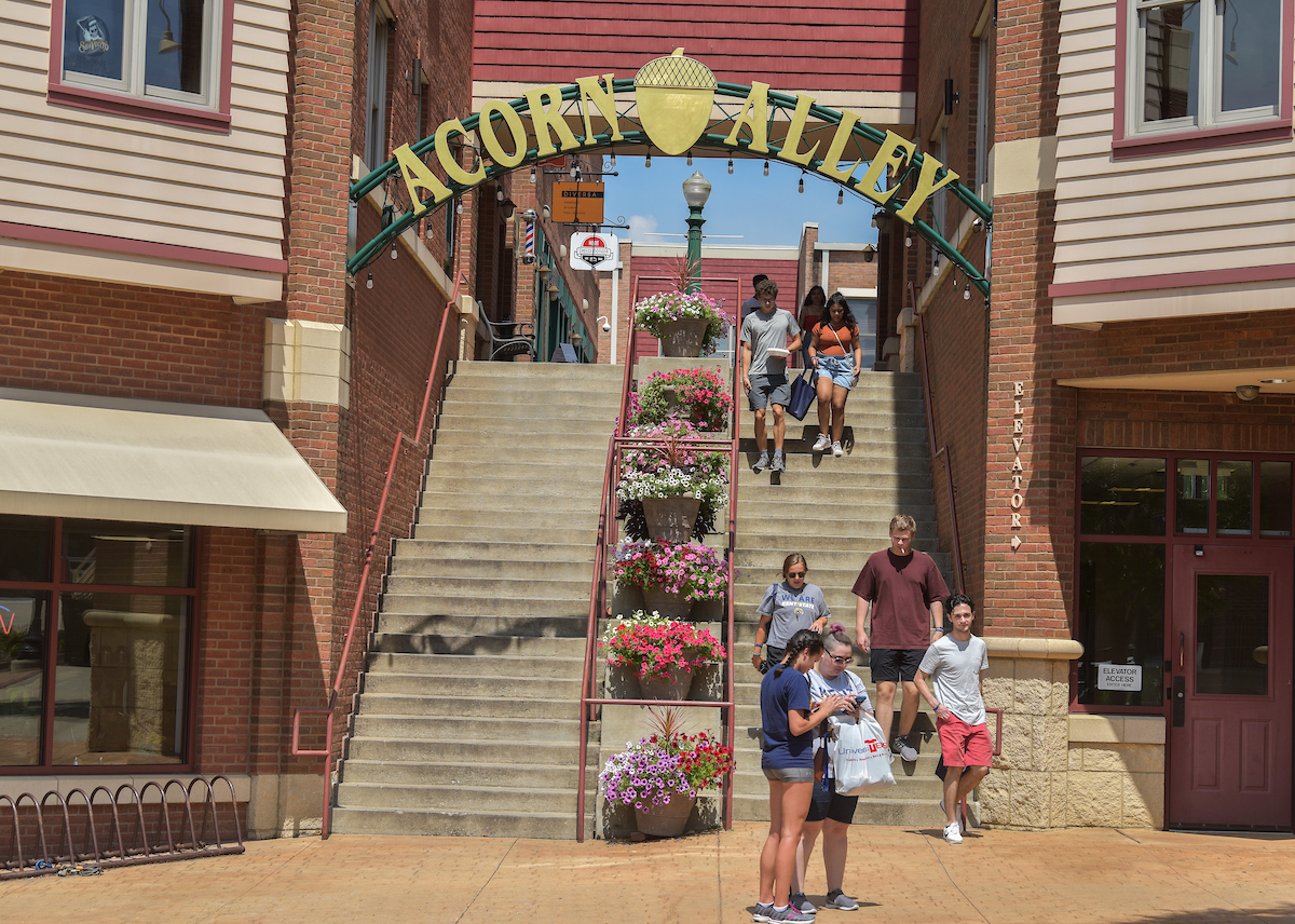 Visitors to Թ, Ohio, explore the downtown area, including Acorn Alley.