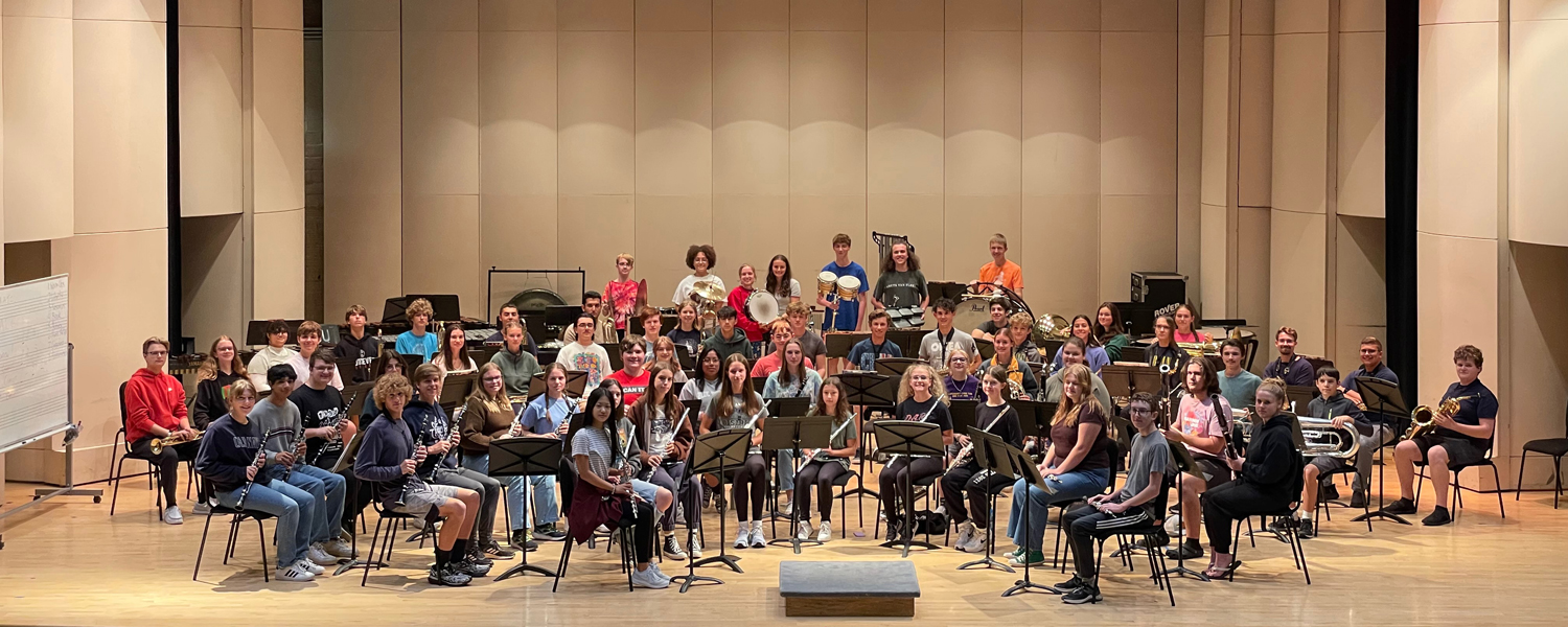 СƬƵ Youth Winds 23-24 Group photo on the stage at Cartwright Auditorium