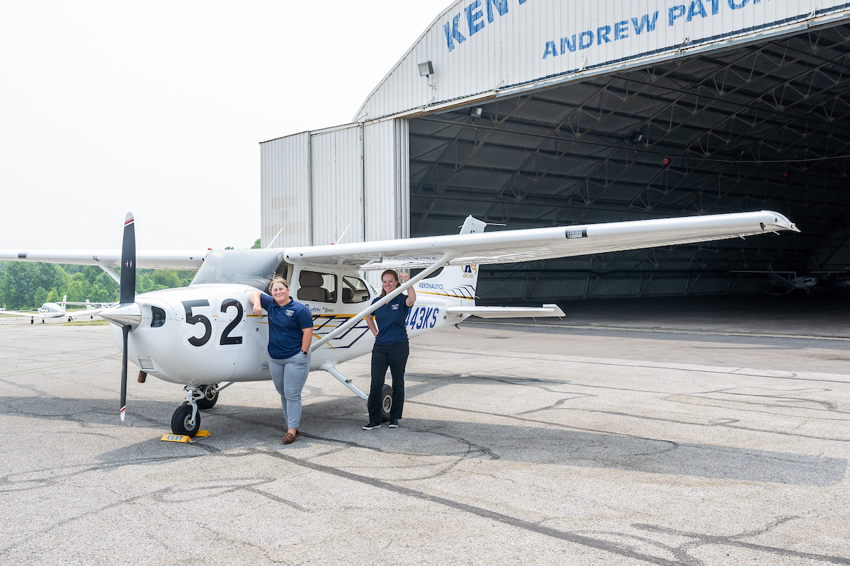Kent State pilots stand by a plane at the Kent State University Airport. Kent State pilots stand by a plane at the Kent State University Airport.