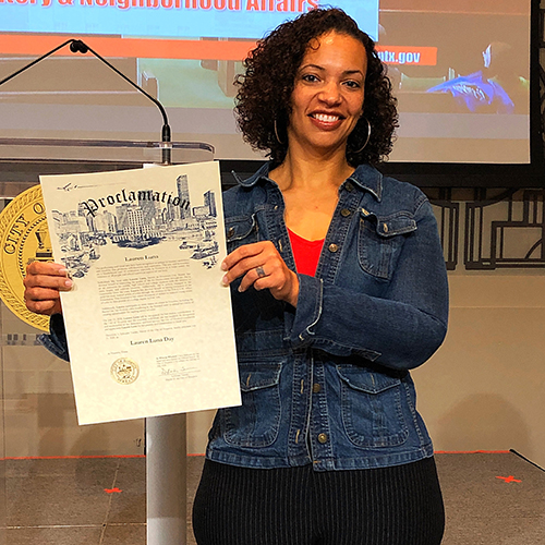 Lauren Luna holding a certificate for a day proclaimed as Lauren Luna Day in Houston, Texas