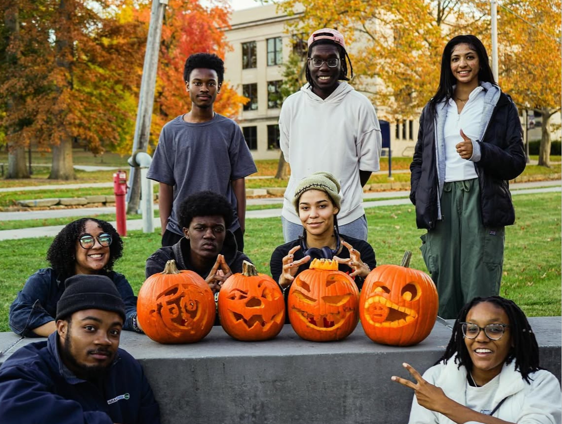 Toby and members of NOMAS pose with carved pumpkins.