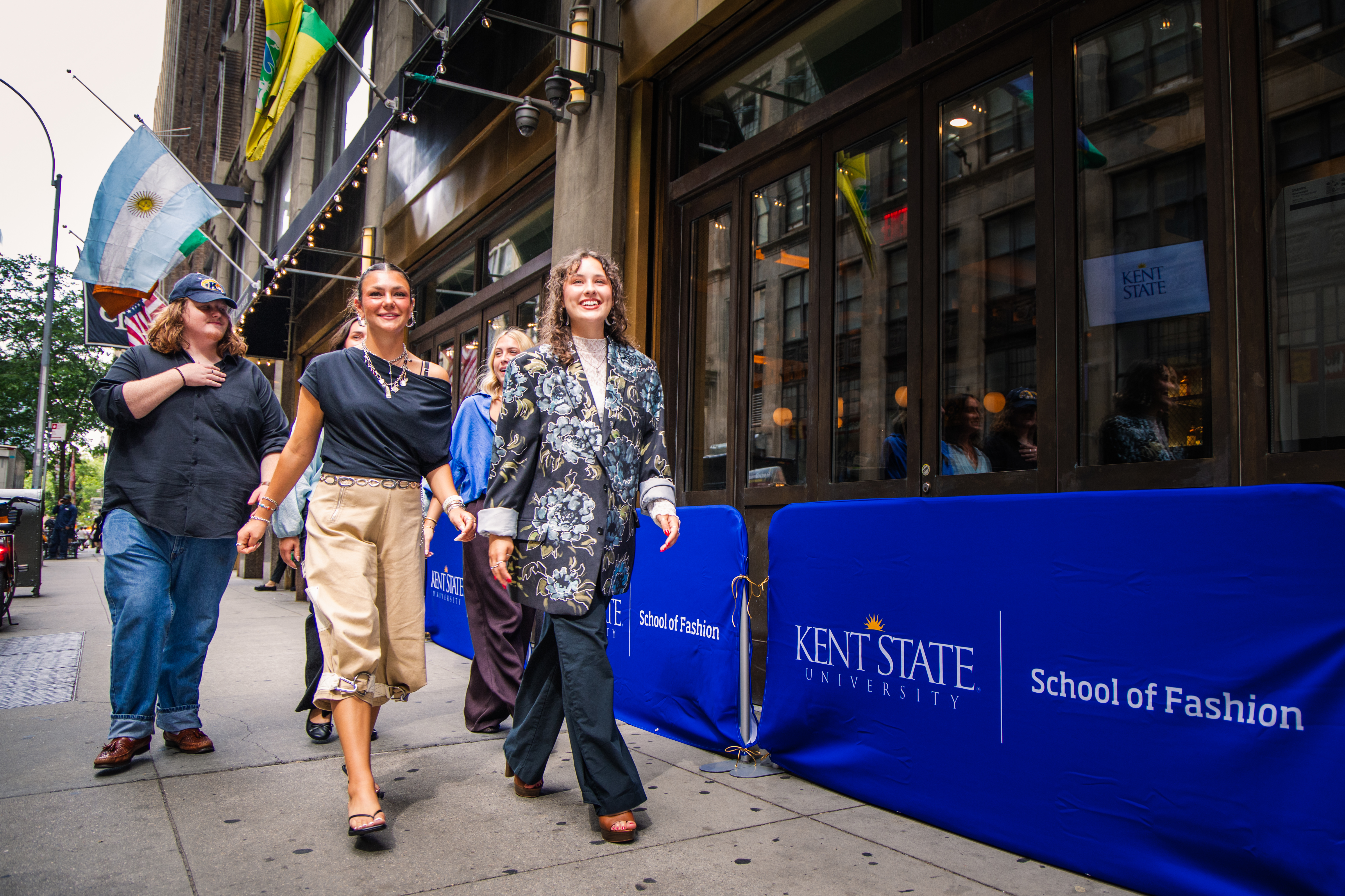 Students walking down the street in NYC for the 20th anniversary of NYC Fashion