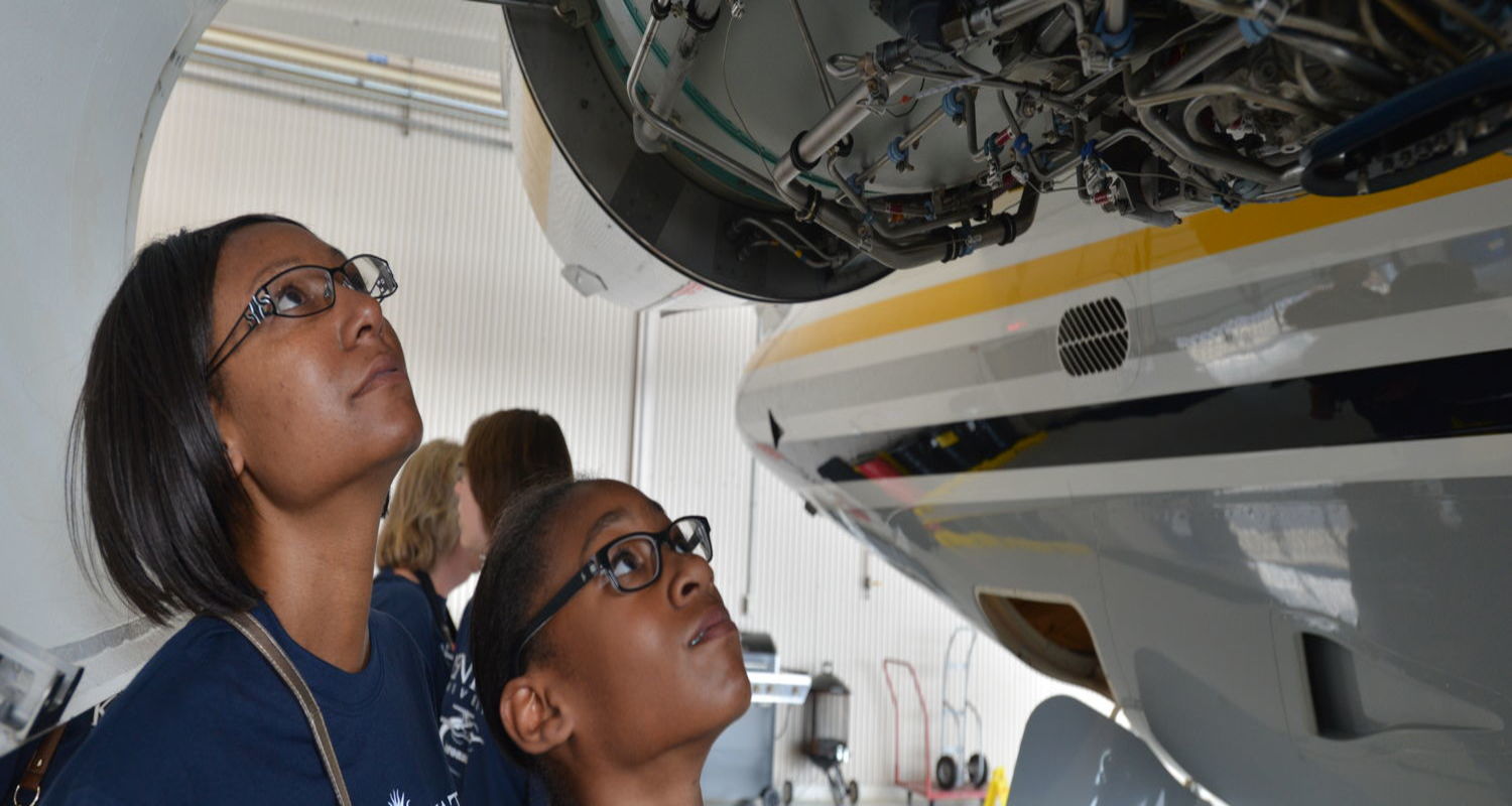 Students looking at aeroplane