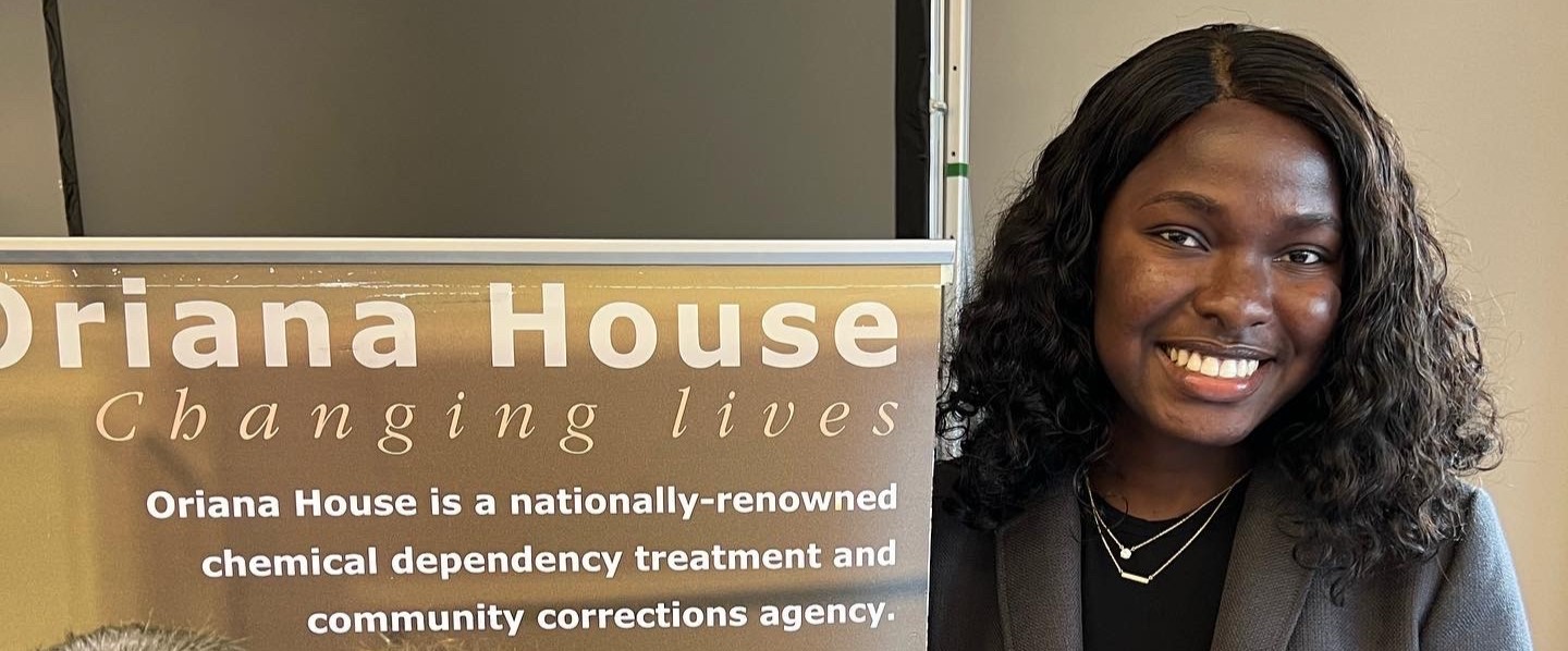 CPH alumna with Oriana House banner