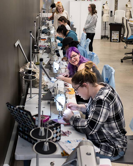 Kent State University Fashion School students create sanitary products for the Days for Girls kits during a sewing workshop.