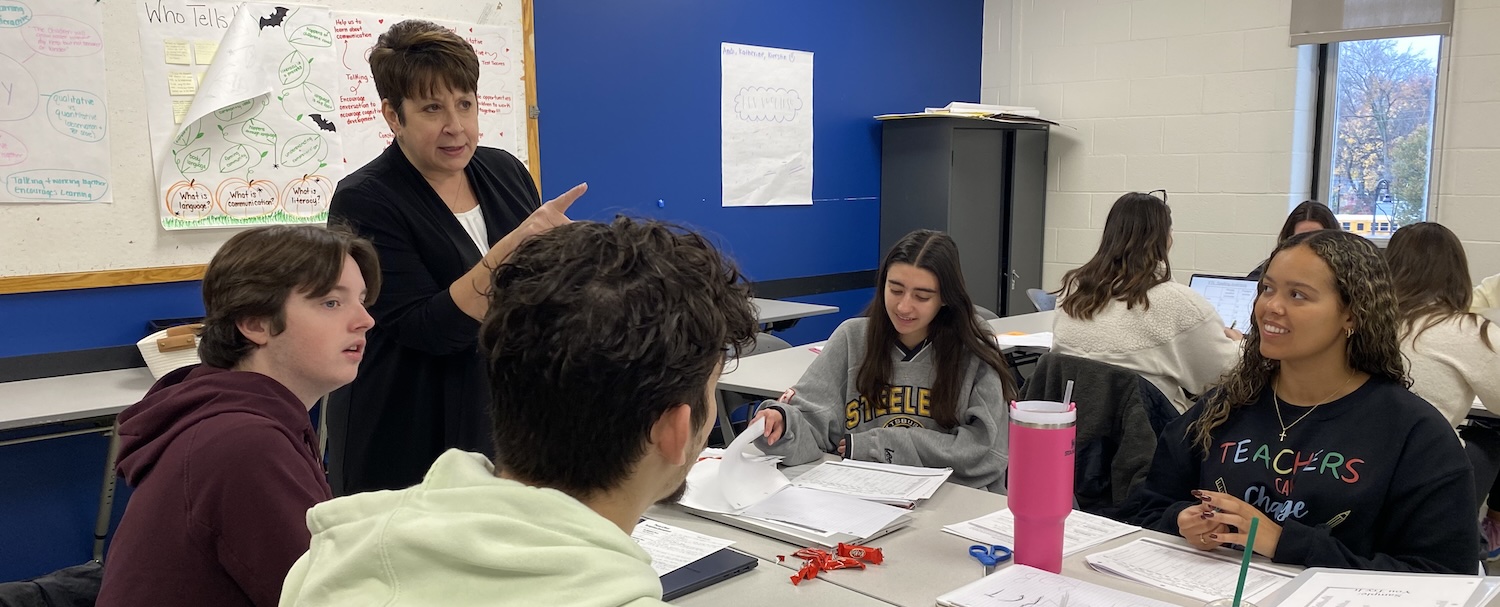 Professor Cheryl Radis instructing a group of students in the classroom