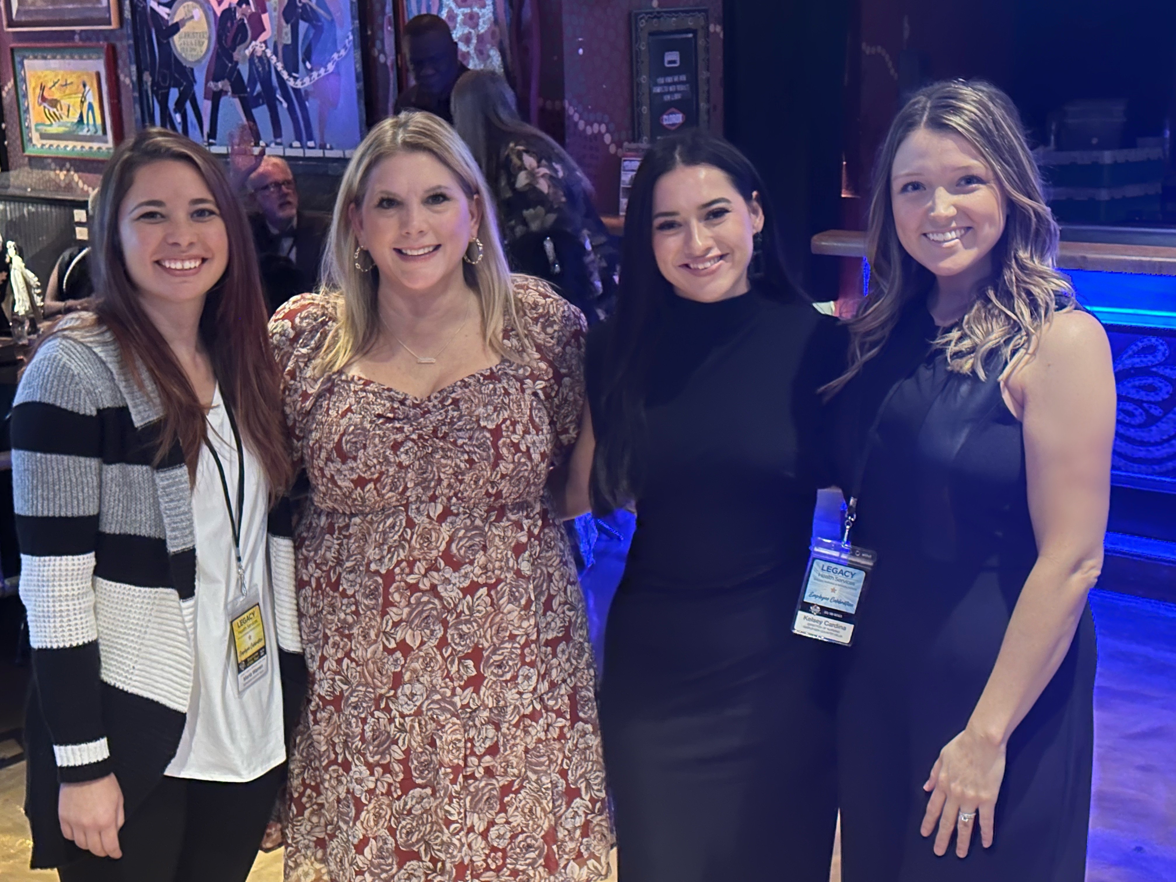 Rachell poses with coworkers at an event