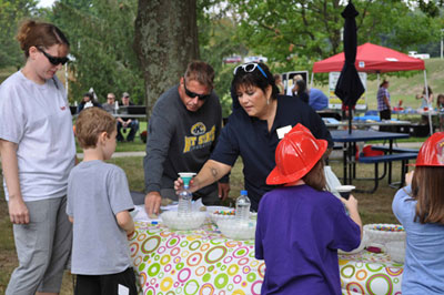 Kim Steele-Marks, director of the Human Development and Family Studies program, helped kids make calming bottles, complete with glitter, beads and bubbles. Kim Steele-Marks, director of the Human Development and Family Studies program, helped kids make calming bottles, complete with glitter, beads and bubbles.