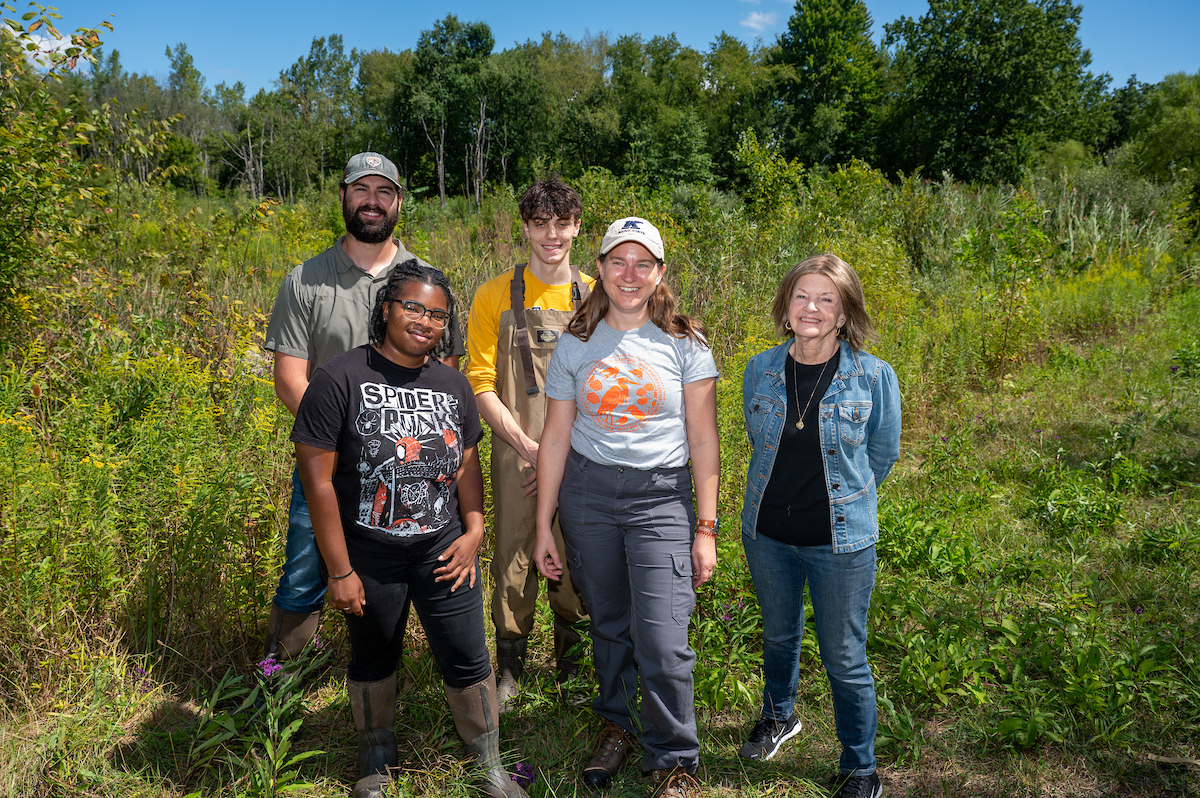 Summer Undergraduate Research Experience students Tamera Owens, left, and Nick Brocato, center rear, stand adjacent to the Herrick Aquatic Ecosystem Research Facility with Lauren Kinsman-Costello, front center, Ann Gosky and Mike Back