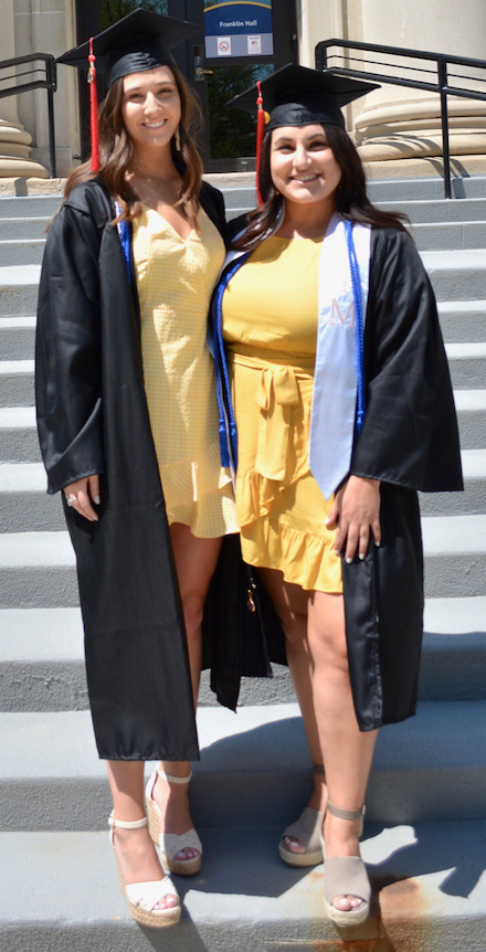 Devon Recktenwald (left) and Samantha Abraham (right) on the steps of Franklin Hall before graduation. 